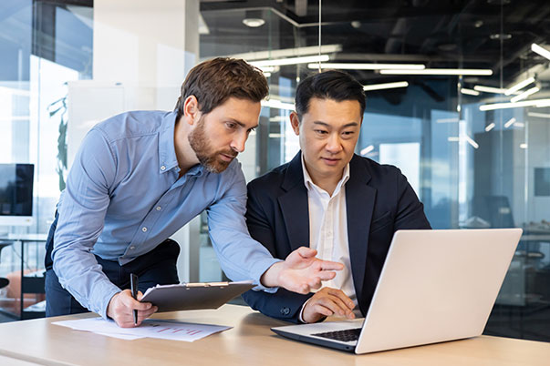 Business Professionals Looking Over Computer